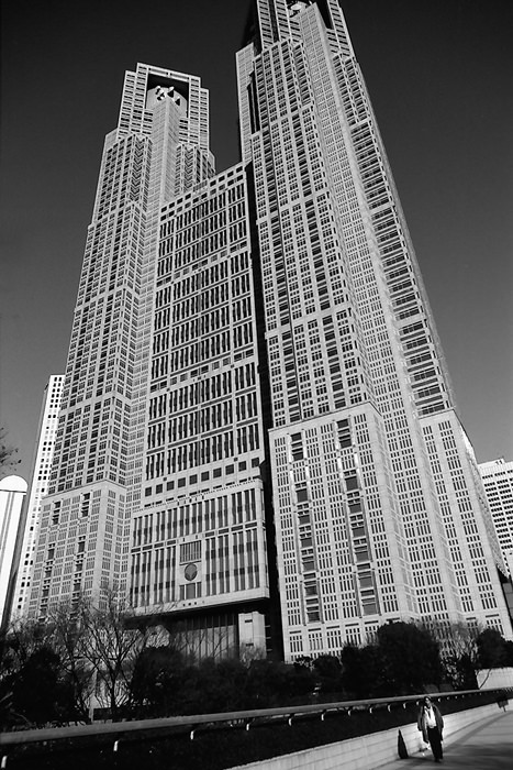small figure and tall city hall