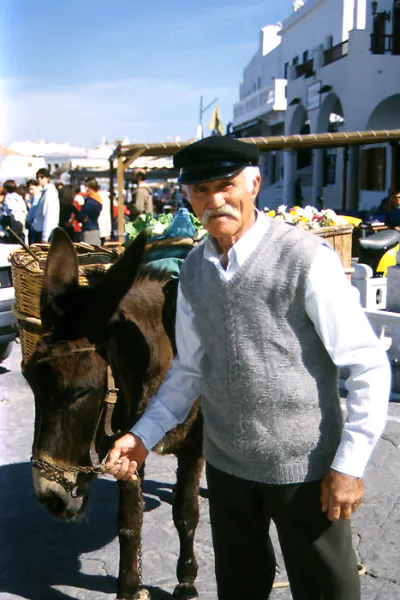 Man with a gorgeous mustache and his donkey