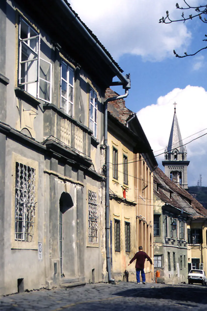 Man walking the street in Sighișoara happily