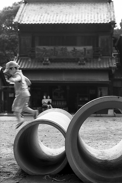 Kid playing on clay pipes