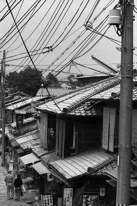 couple walking under electric wires