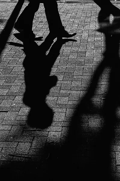 Shadows of pedestrian on ground