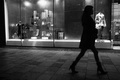 woman in high heels walking in front of a show window
