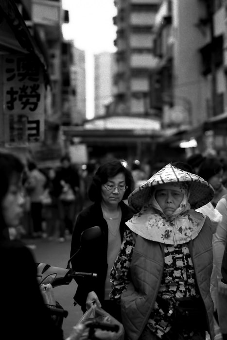 Older woman wearing conical hat