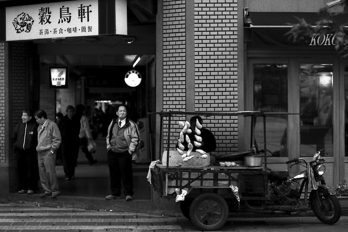 Man standing in corner of street