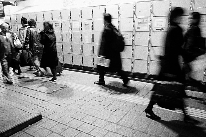 Pedestrians in front of lockers
