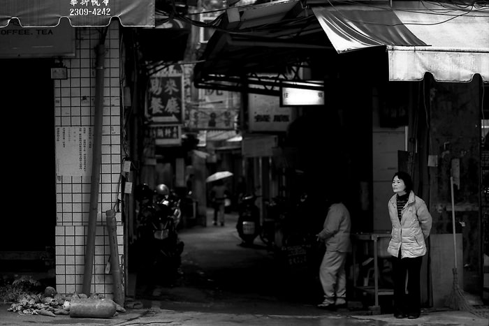 Woman standing in corner of street