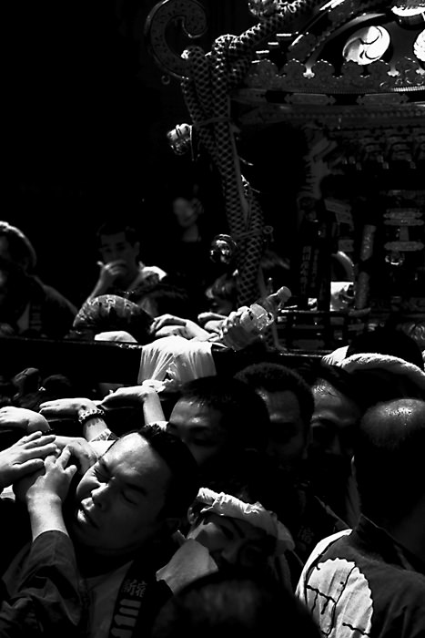 people carrying portable shrine