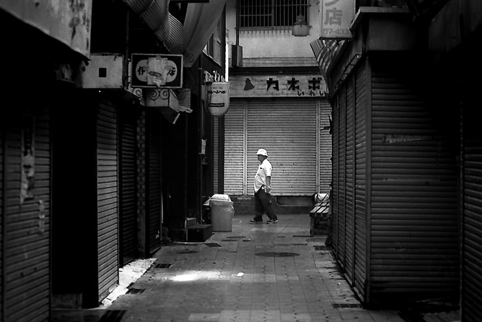Man and shuttered stores