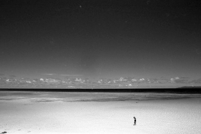 Lonely figure in shallow water