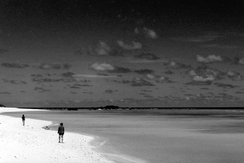 Two figures on edge of water