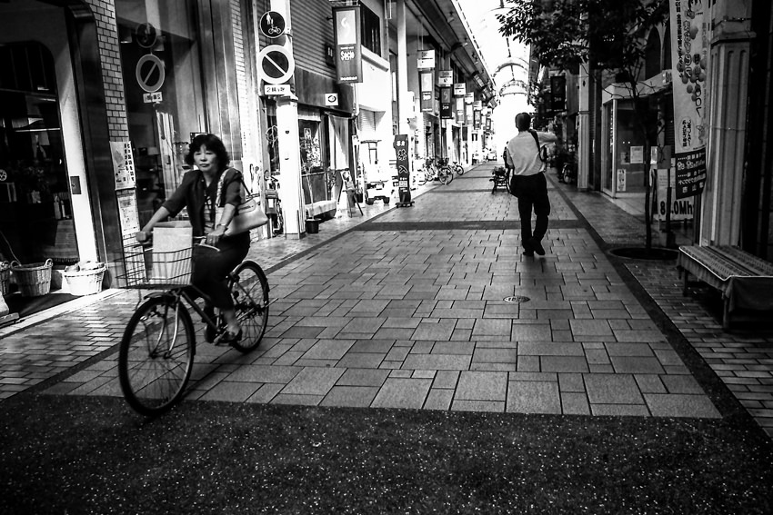 Bicycle running shopping arcade