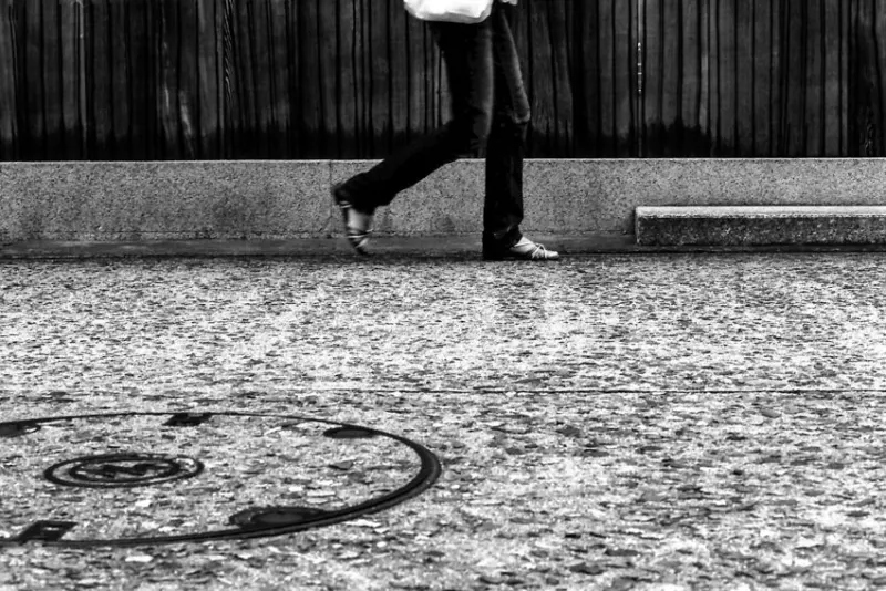 Legs of young woman against wall