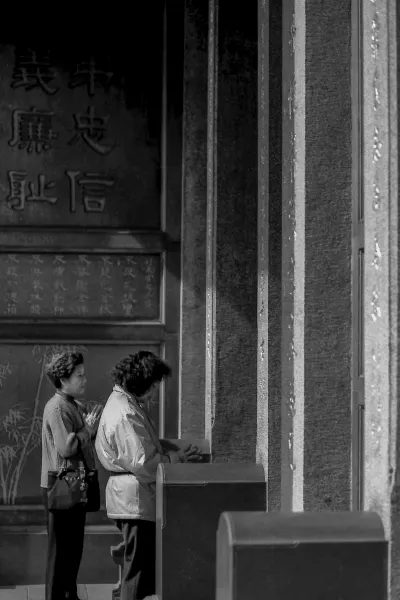 Women standing in front of door in Hsing Tian Kong Temple