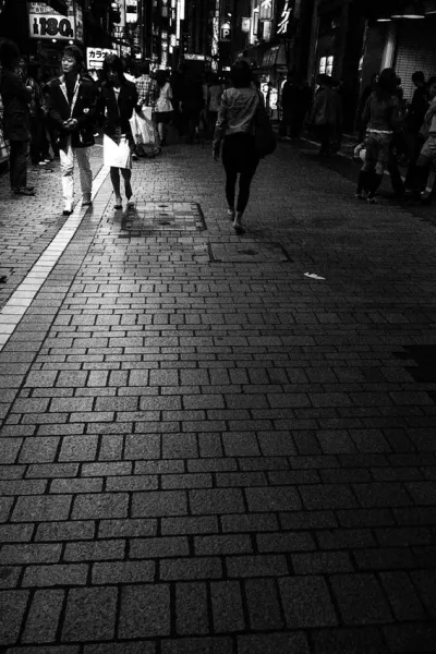Pedestrians walking at night