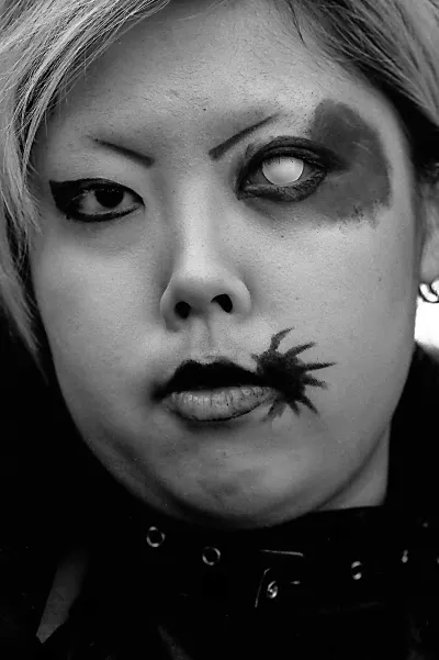 girl with enigmatic sign beside her lips