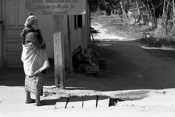 Akha Woman Standing By The Roadside (Laos)