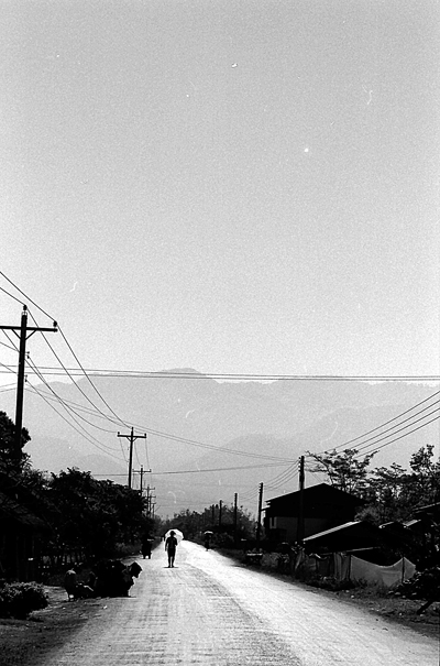 Silhouette With Umbrella Stood On The Road (Laos)