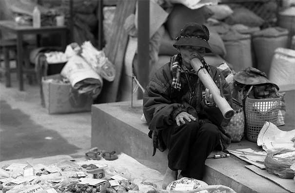 man smoking thick pipe