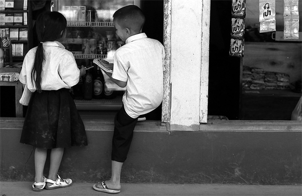 Girl and boy standing together in storefront