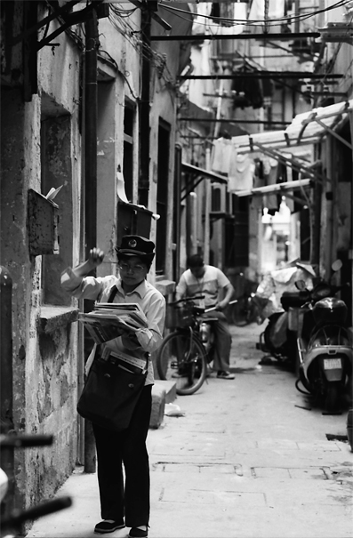 Postwoman delivering in lane