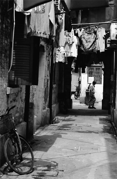 Man Walking Across The Alleyway (China)