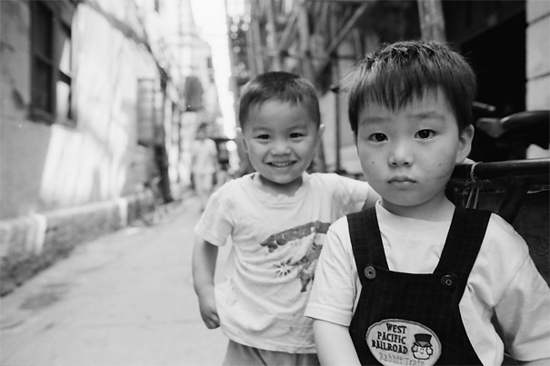 Two little boy playing together in lane