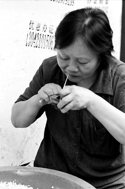 Woman making Zongzi