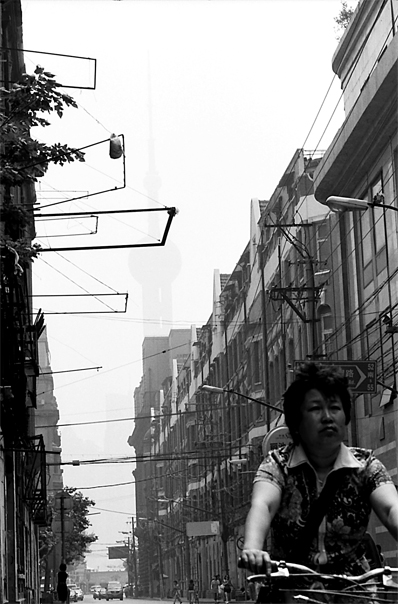 Woman Sprinting Between Buildings (China)