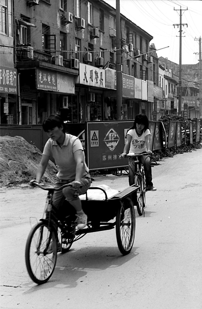 Tricycle and bicycle running together