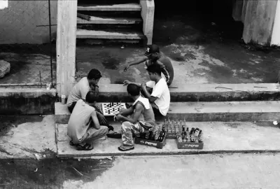 Some men playing chess in market