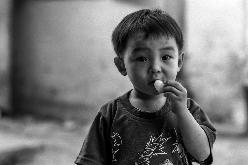 Boy looking while eating snack