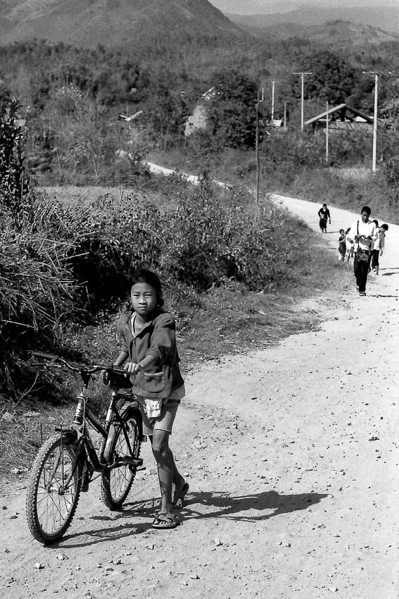 Girl walking bicycle