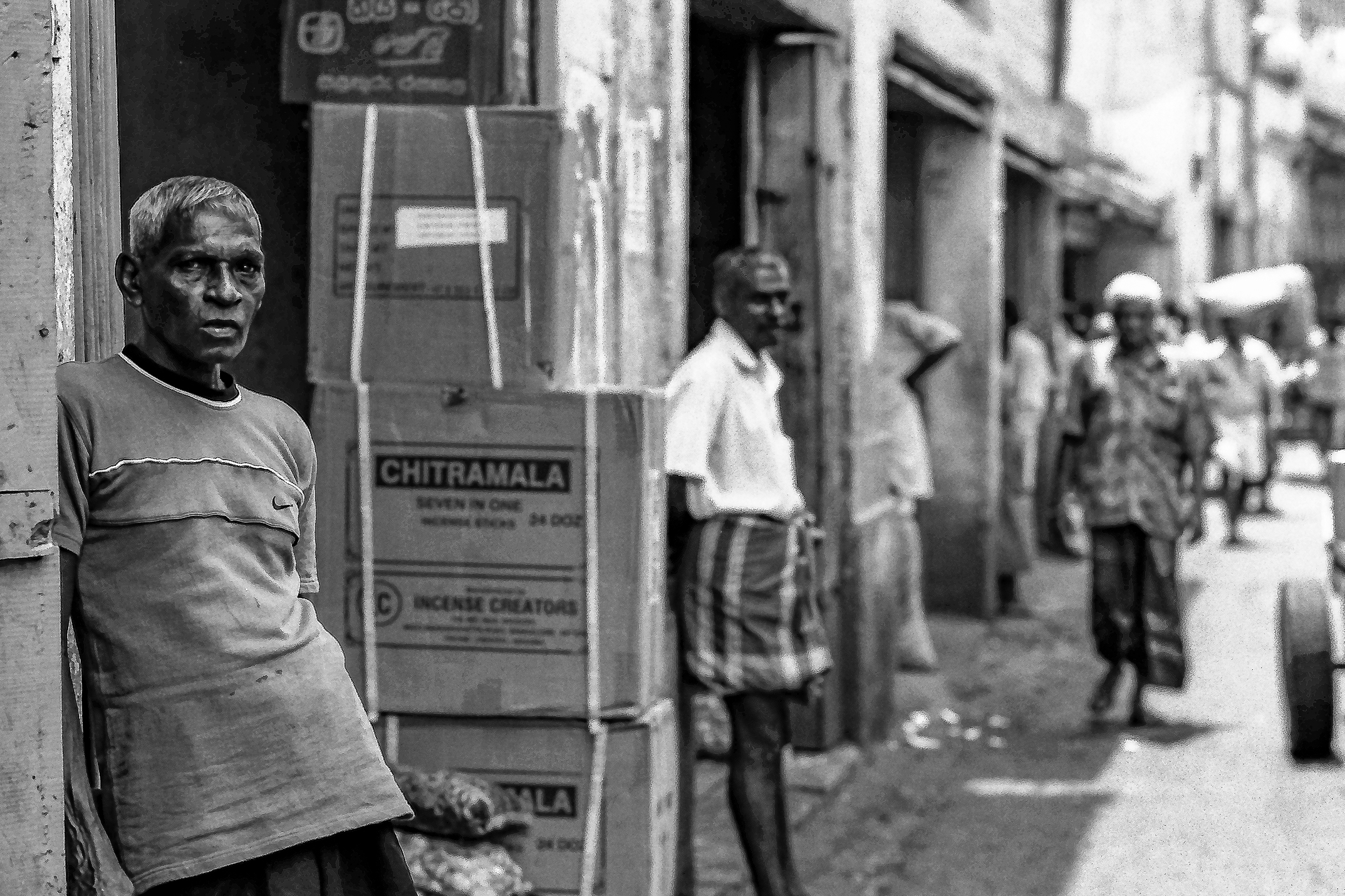 Sri Lankans walk on a deserted street at a wholesale market during