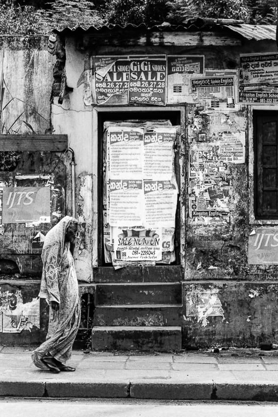 Woman with a saree in front of boarded-up door