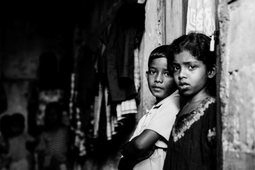 Boy and girl standing in dimness