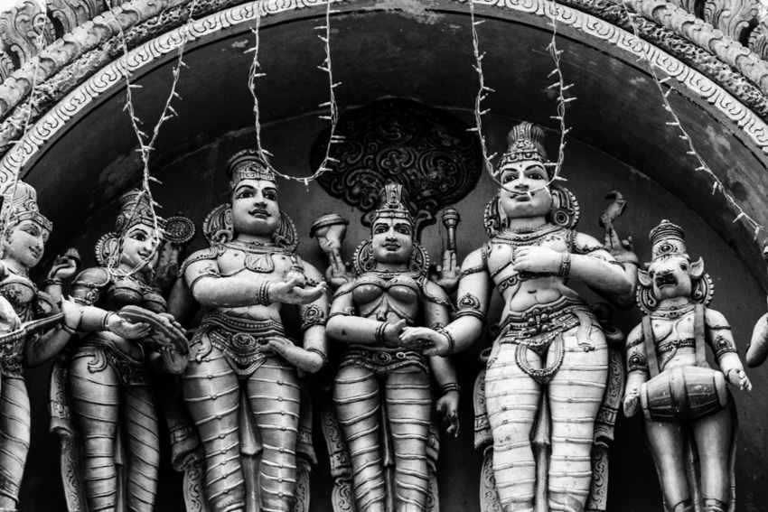 Hindu deities standing on roof of temple