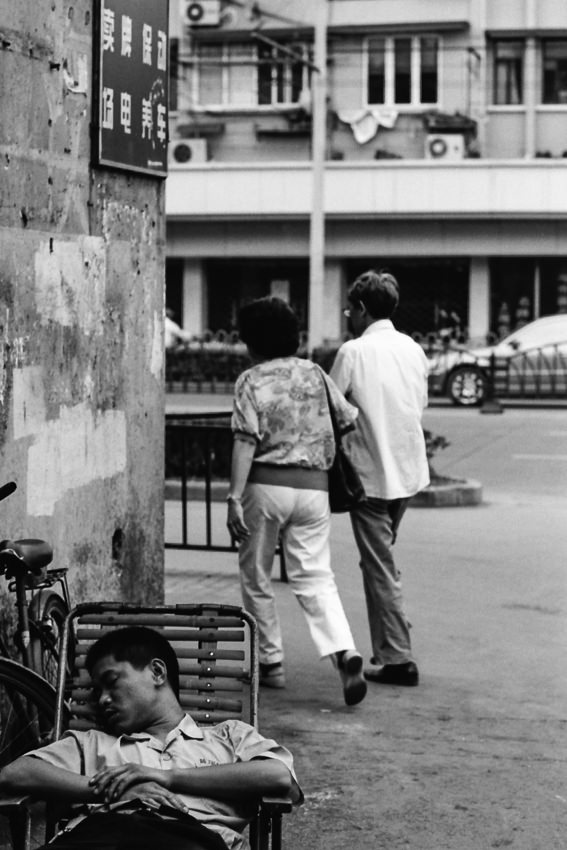 Man taking nap in street corner