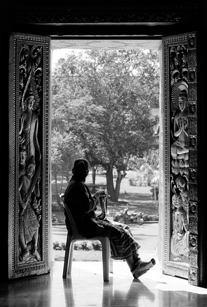 Woman Knitting In The Temple (Laos)