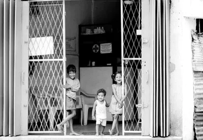 Three kids standing at gate