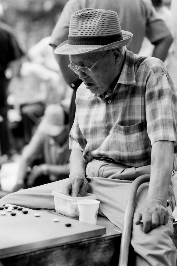 Old man playing Go in park