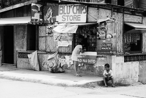 Woman And Boy In Front Of A Store (Philippines)