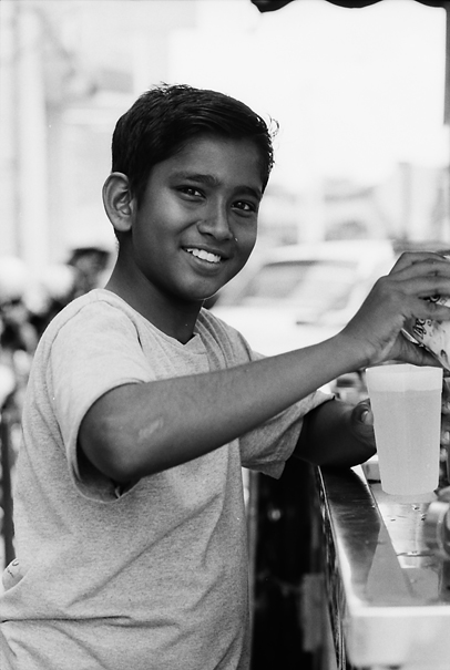 Smiling Boy At A Juice Stand (Malaysia)