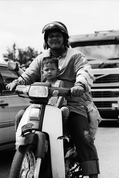 Father And His Son On A Honda Motorbike (Malaysia)