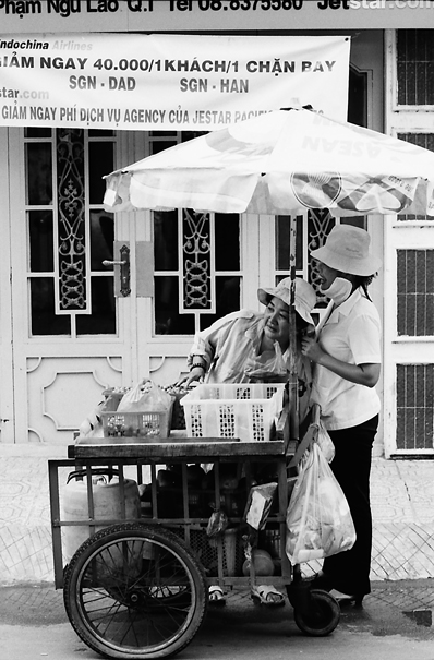 Two Women At A Food Stall (Vietnam)