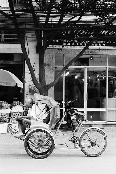Man On The Seat Of A Cyclo (Vietnam)
