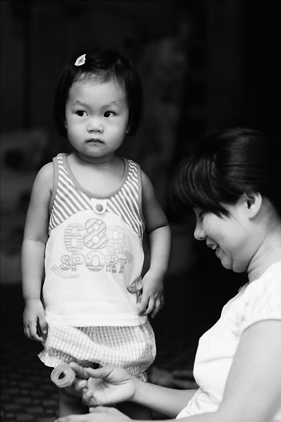Girl Standing Beside Her Mother (Vietnam)