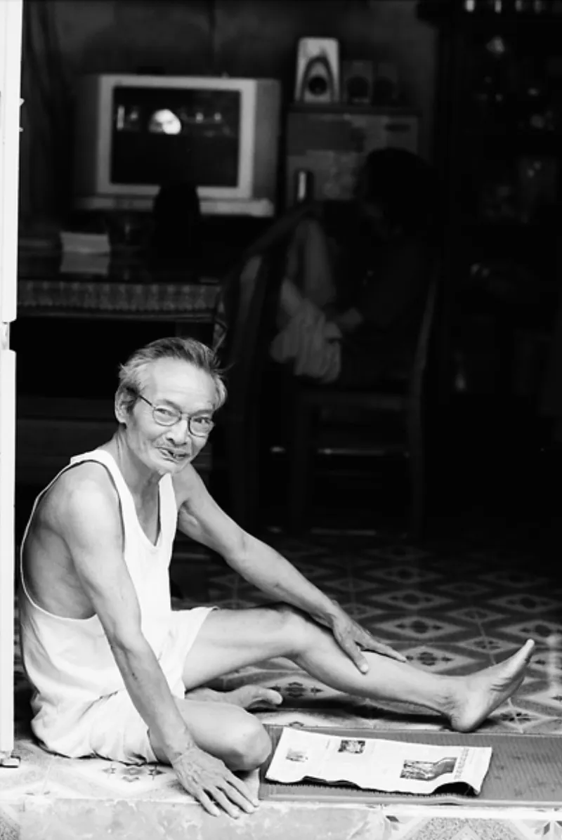 Man reading newspaper at entrance