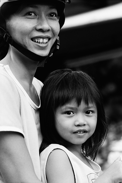 Mother And Her Daughter Cuddling Up Together (Vietnam)