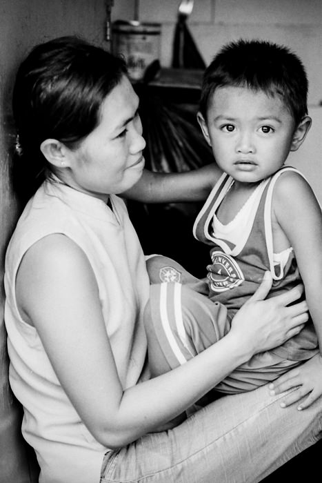 Boy sitting on mother's knees